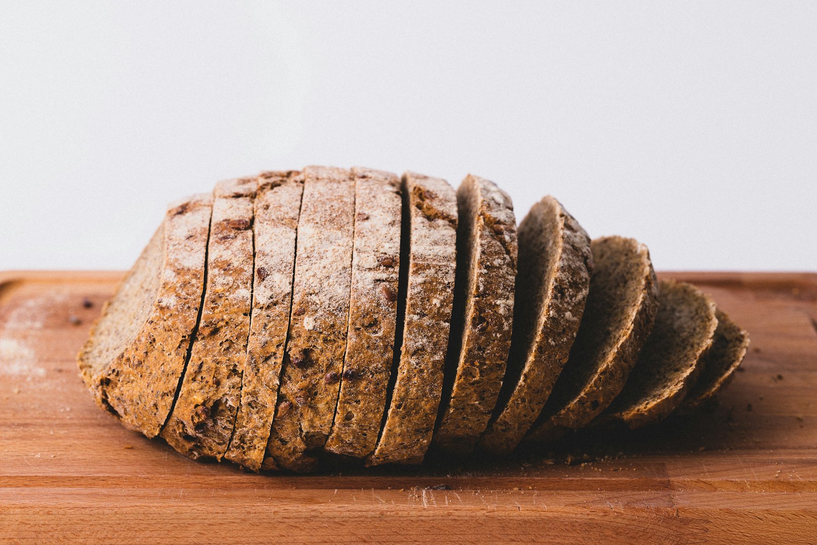 Sliced dark rye bread on a wooden board